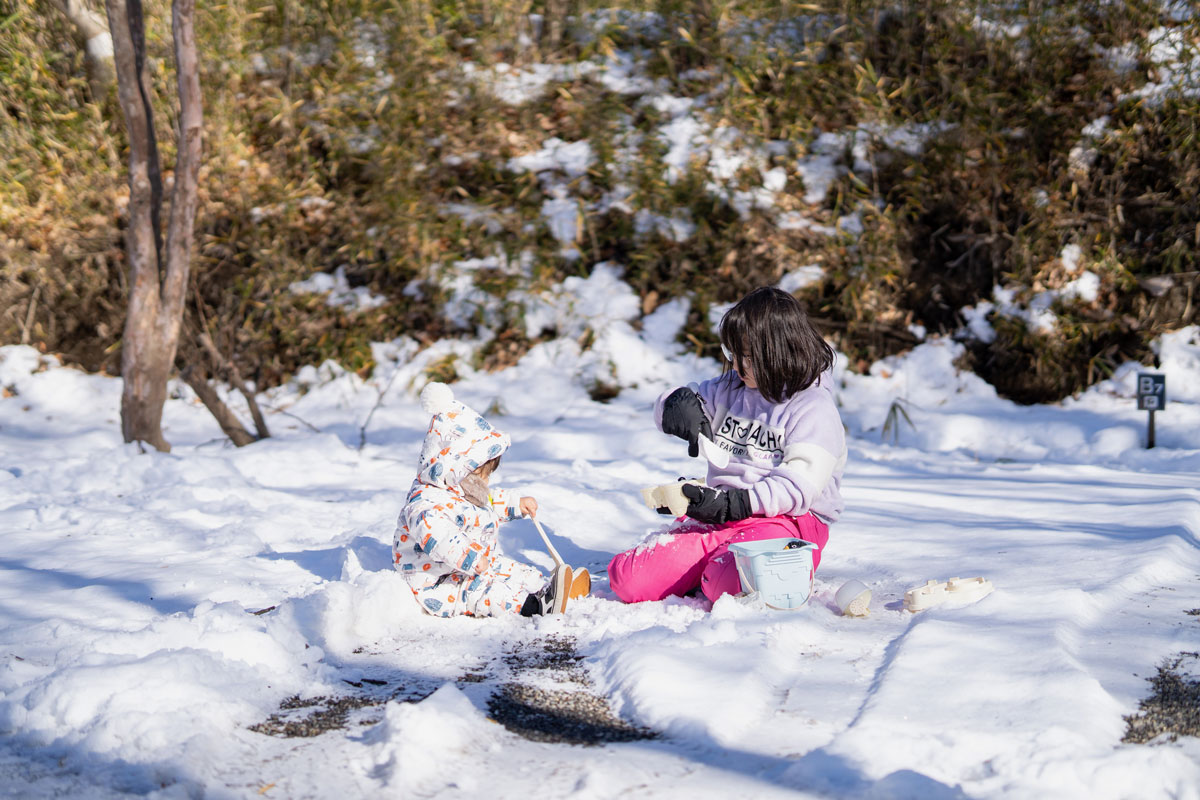 雪の中で遊ぶ子どもたちの写真