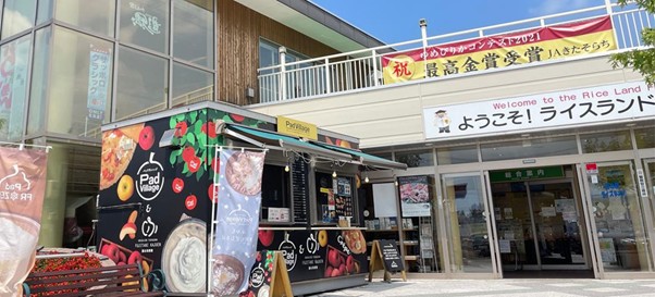 「ライスランドふらの」と書かれた建物の前にある、フードトラックとバナー。